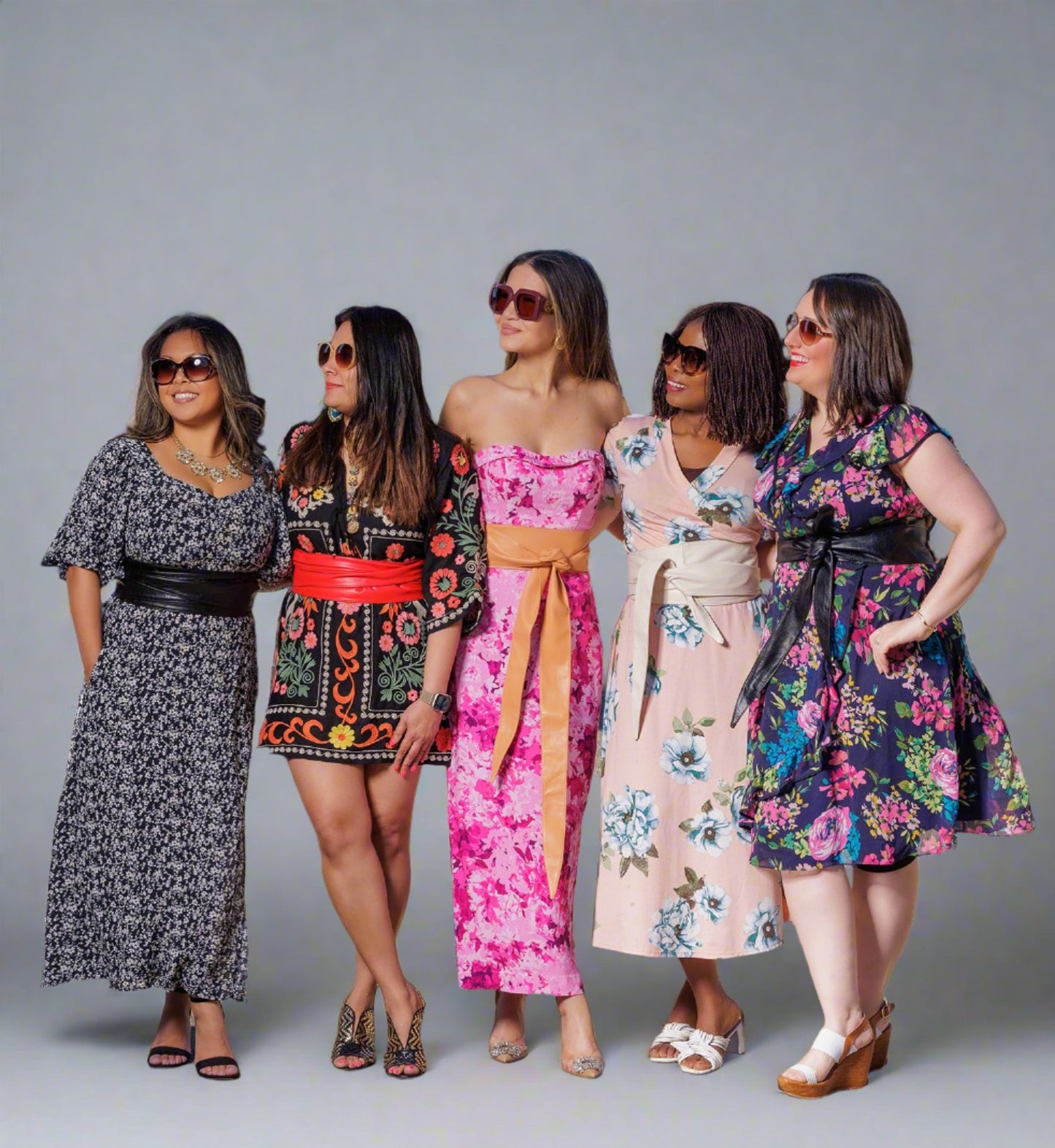 Diverse women wearing floral dresses and TTOS Belts wrap belts